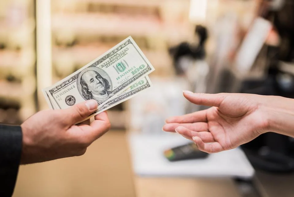 Merchant dual pricing terminal showing cash and card price options
